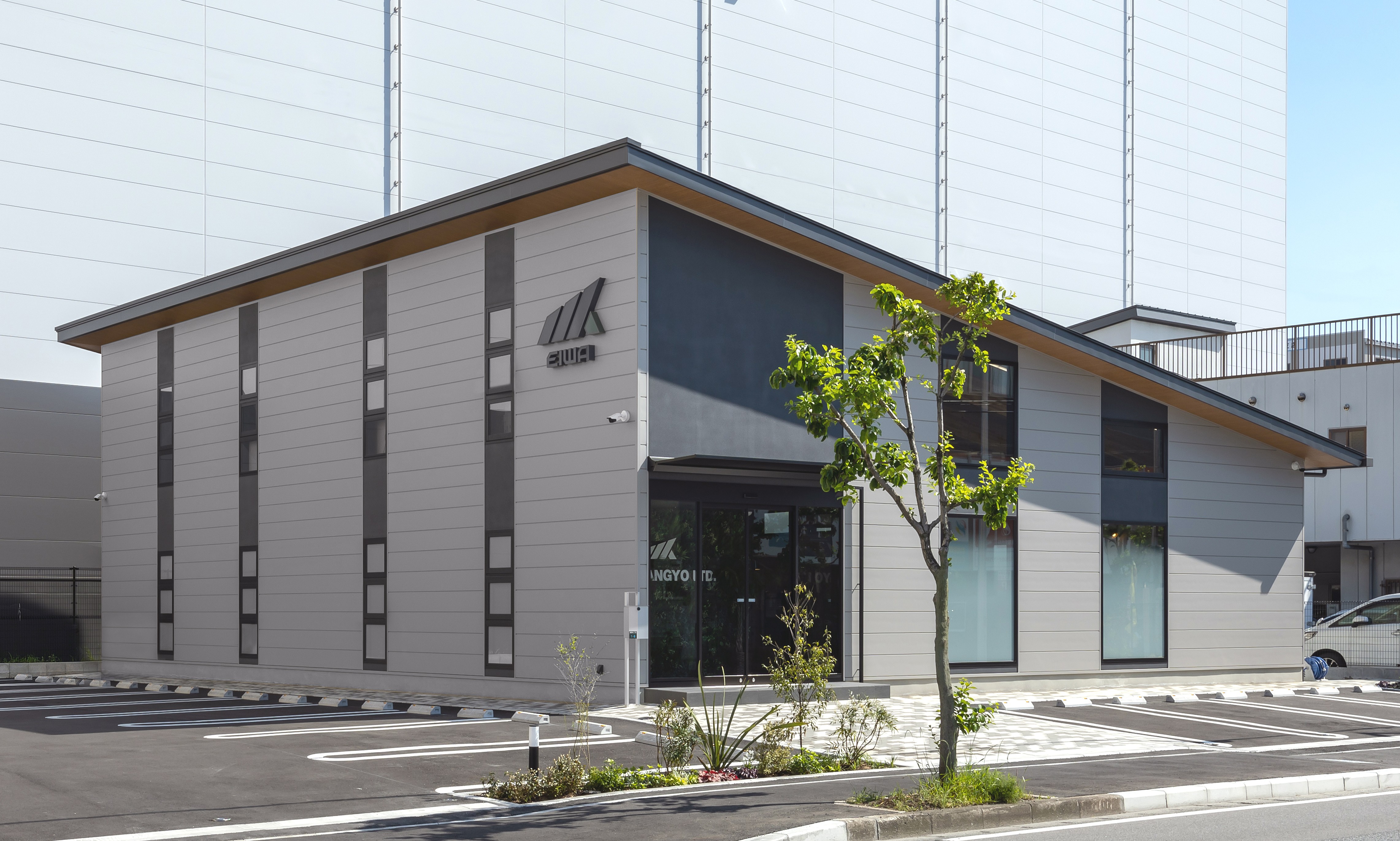 株式会社エイワ産業の白色の基調とした２階建て事業所の外観