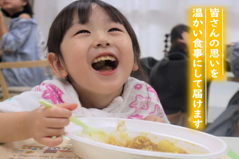 子どもが笑顔でご飯を食べている写真
